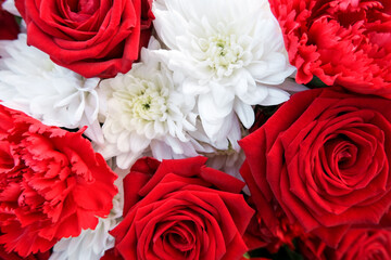 Close-up red and white bouquet of solemn festive flowers of fresh bright carnations, roses with...