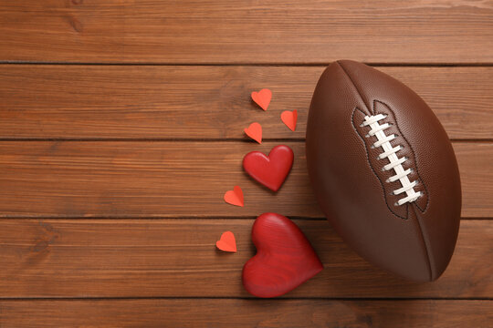 American Football Ball And Hearts On Wooden Background, Flat Lay. Space For Text