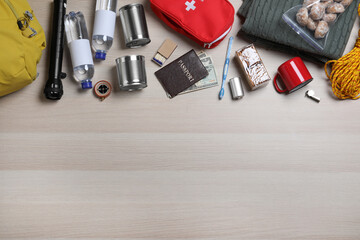 Earthquake supply kit on wooden table, flat lay. Space for text