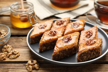 Delicious sweet baklava with walnuts on wooden table, closeup