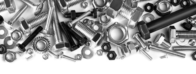 Different metal bolts and nuts on white background, top view