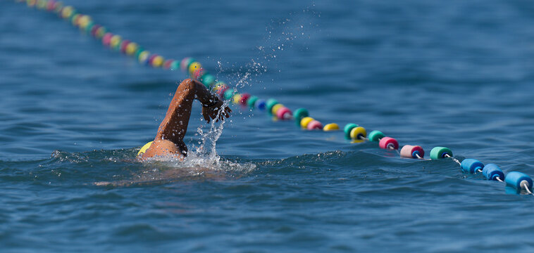Swim competition swimmer athlete doing crawl stroke in sea swimming