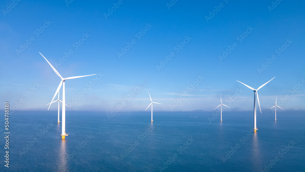 Wall mural Offshore Windmill farm in the ocean Westermeerwind park, windmills isolated at sea on a beautiful bright day Netherlands Flevoland Noordoostpolder. Huge windmill turbines