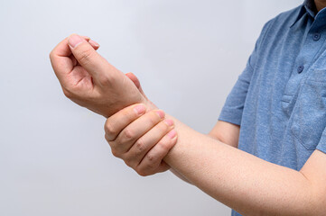 A man wrapped around his wrist because of wrist pain. Causes of rheumatoid arthritis, carpal tunnel syndrome, gout. Health care and medical concept.