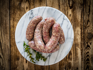 Raw white sausages on wooden table
