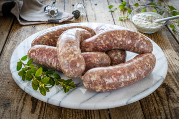 Raw white sausages on wooden table
