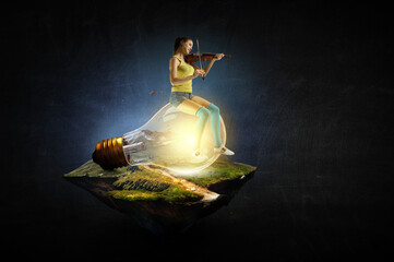 Girl plays on violin sitting on light bulb