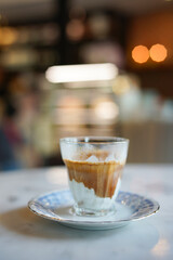 cup of coffee with milk, dirty coffee.  A glass of espresso shot mixed with cold fresh milk in cafe