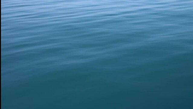 Surface water texture for background. Horizontal footage.   Calm and relaxing background with clear sea ripples.