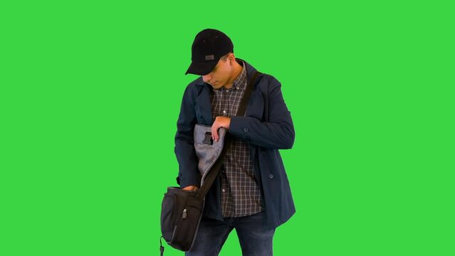 Ethnic latin delivery man or postman come to client giving letter mail to addressee with happy smile on a Green Screen, Chroma Key.