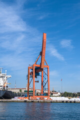 Crane loading ship at port.