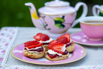 Freshly baked scones with tea served in the garden