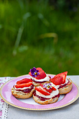 Freshly baked scones with tea served in the garden