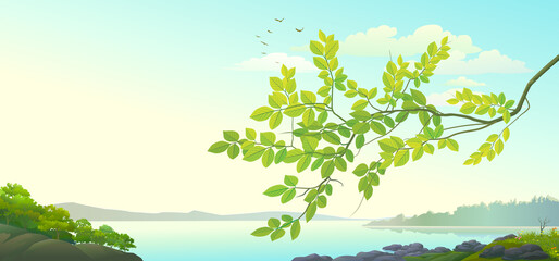 A branch of a tree with green leaves with a background landscape of river and mountains.