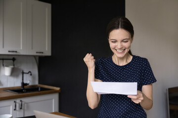 Joyful happy student girl excited with good news, making win hand, reading letter from college,...