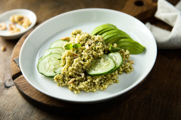 Couscous with pesto, cucumber and avocado