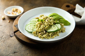 Couscous with pesto, cucumber and avocado