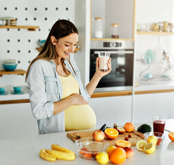 woman pregnant food healthy juice fruit kitchen pregnancy resh diet mother preparing drink smoothie...