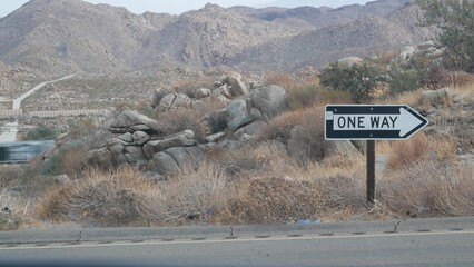 One way road transport sign with arrow on roadside or wayside, highway or freeway in California...