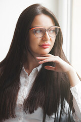 Closeup portrait of young lady indoors. Woman in cafeteria. Attractive brunette woman.