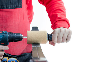 The serviceman at the ski service prepares the sliding surface of cross-country skis for...