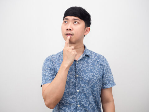 Portrait asian man gesture touch his mouth thinking about choosing