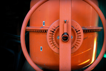 abstract detail of an orange cement mixers bowl and mechanisms