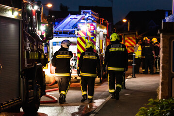 Three firefighters and other members of the emergency services after fighting a vehicle fire in...