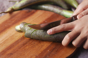 cutting eggplant on a chopping board 