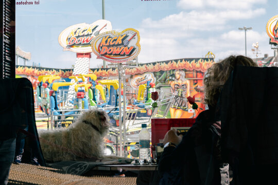 Augsburg, Germany 28.04.2022: cashier and her dog work in amusement park