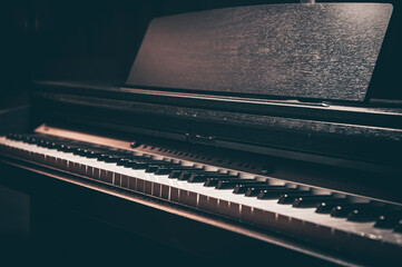 Fototapeta na wymiar Close-up, electronic piano in a dark room.
