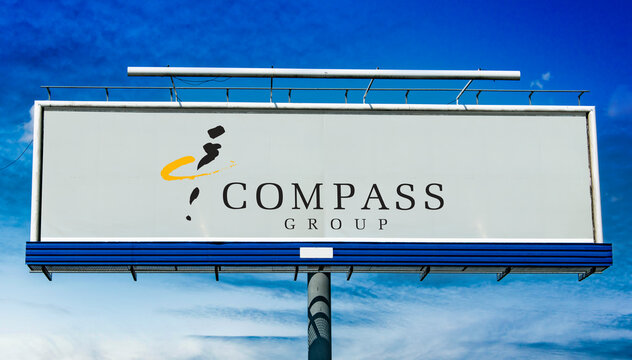 Advertisement billboard displaying logo of Compass Group