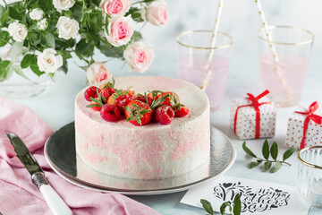 festive cake decorated with strawberries on a light background. Sweets concept for Mothers Day