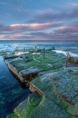 Sunrise over Bogey hole built by convicts, Newcastle, NSW, Australia