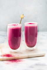 Pink matcha latte with milk. Trendy drink from dragon fruit powder