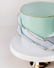 festive big light  blue cake on a gray background. Sweets concept . Macro detail