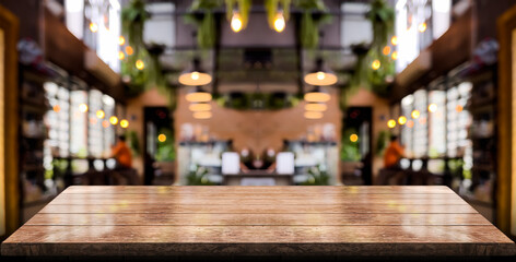 Empty wooden table top with lights bokeh on blur restaurant background.	