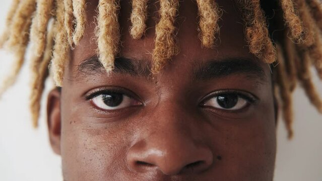 Sad eyes. Soul reflection. Hope freedom. Vision correction. Closeup of man with serious unhappy tired face blond dreadlocks hairstyle isolated on white.