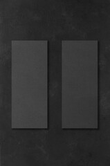 Black rectangular mockups on a dark concrete background. Design elements or portfolio. Copy space