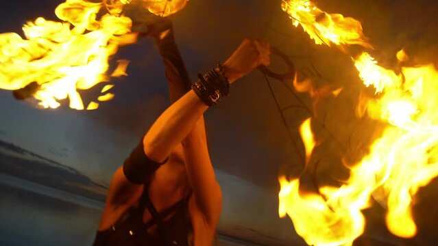 Dynamic fire show. Sexy couple perform poi dance blue sky. Poi performance. Fire dancing. celebration. Performing art. Fun and entertainment