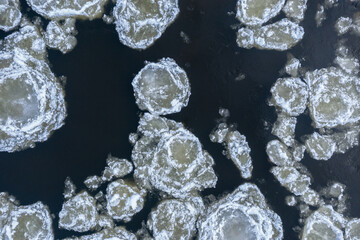 Close up of broken ice in flowing river © M