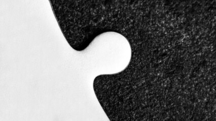 Closeup of white jigsaw puzzle on black background
