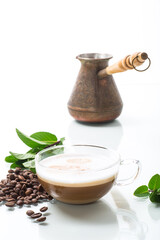 Cup of coffee latte with heart shape and coffee beans