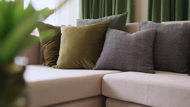 home interior design detail of Modern clean living room with soft and cozy sunlight pillow upholsty curshion arrange on white sofa dolly shot close up,home sweet home background