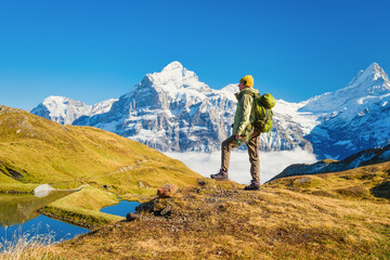 Tourist with a backpack in the mountains. Mountain hiking in the high mountains. Travel and...