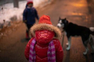 Child in red jacket. Child is outside in winter.