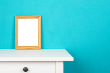blank photo frame mockup on stand against blue wall, minimalism concept, Interior design