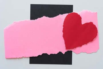 torn pink paper with torn red paper heart