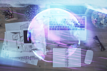 Technology hologram drawing over computer on the desktop background. Top view. Double exposure. Tech concept.