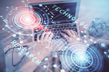 Double exposure of man's hands typing over computer keyboard and data theme hologram drawing. Top view. Technology concept.